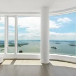 A large window overlooking the ocean and boats.