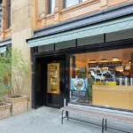 A store front with a bench outside it