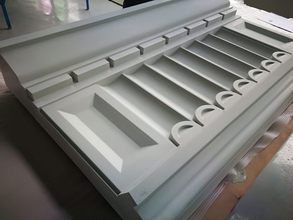 A white table with many drawers and some cups