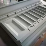 A white table with many drawers and some cups