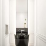 A bathroom with a sink and mirror in it