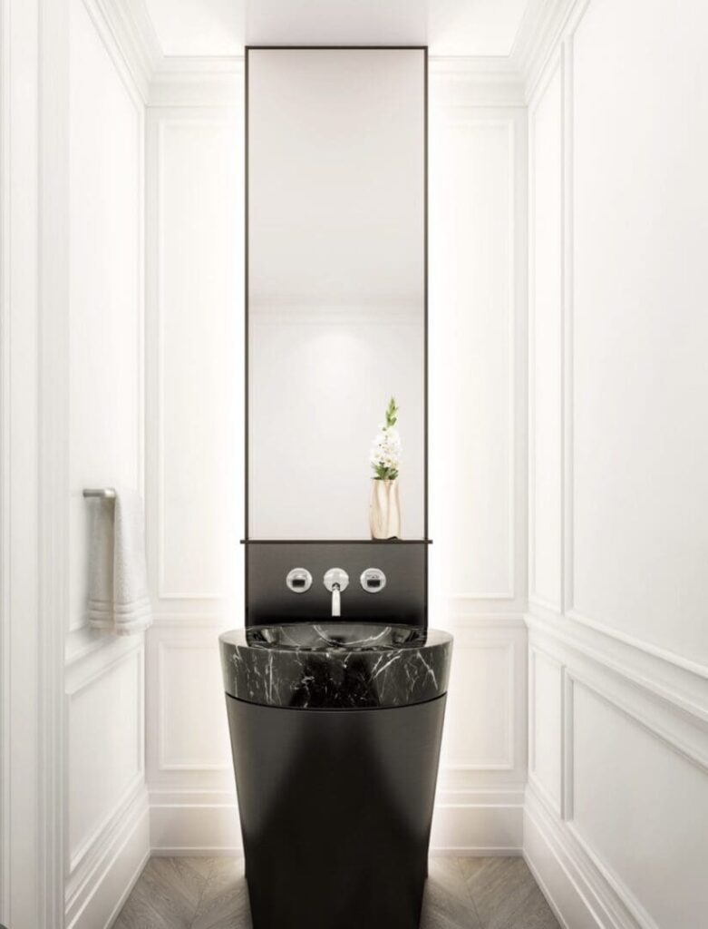 A bathroom with a sink and mirror in it