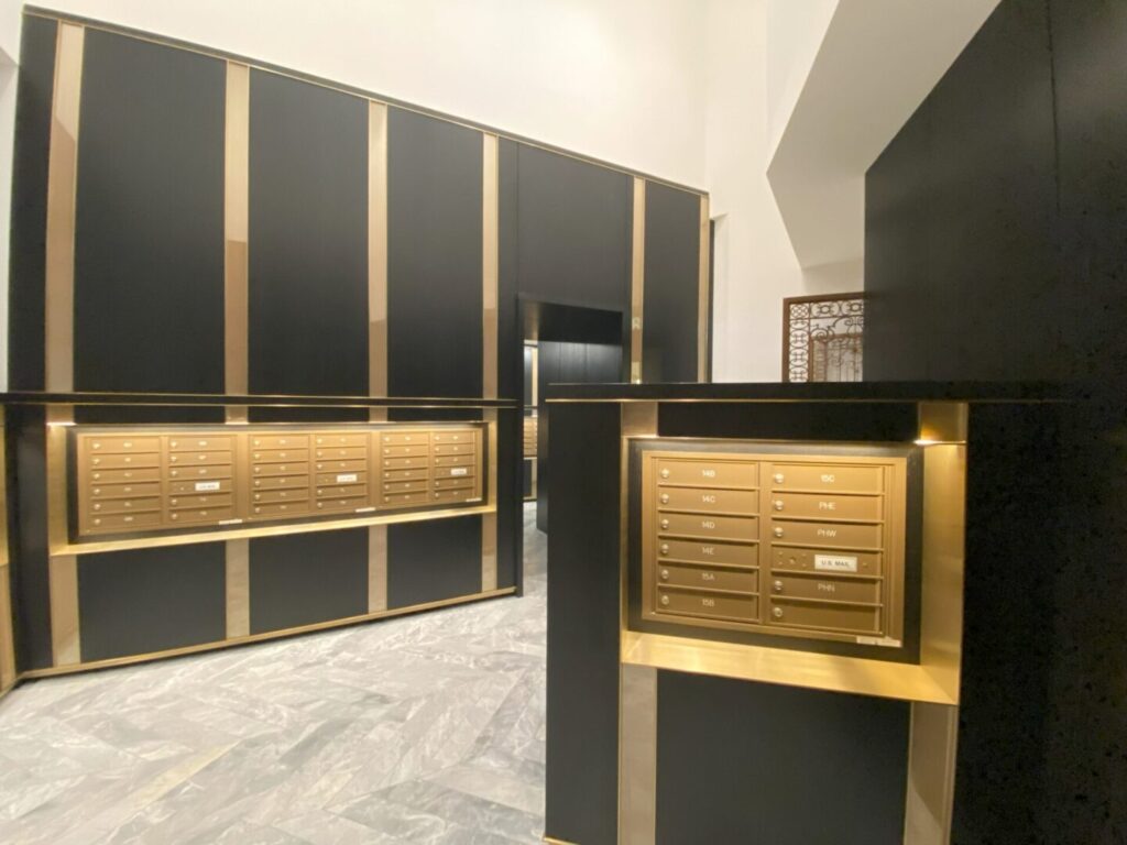 A room with black and gold walls, a large wall of cabinets.