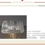 Three transparent, ribbed glass cups on a reflective surface.