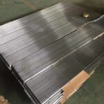 A pallet of metal sheets on top of a wooden crate.