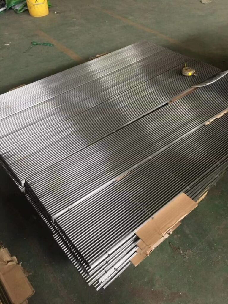 A pallet of metal sheets on top of a wooden crate.