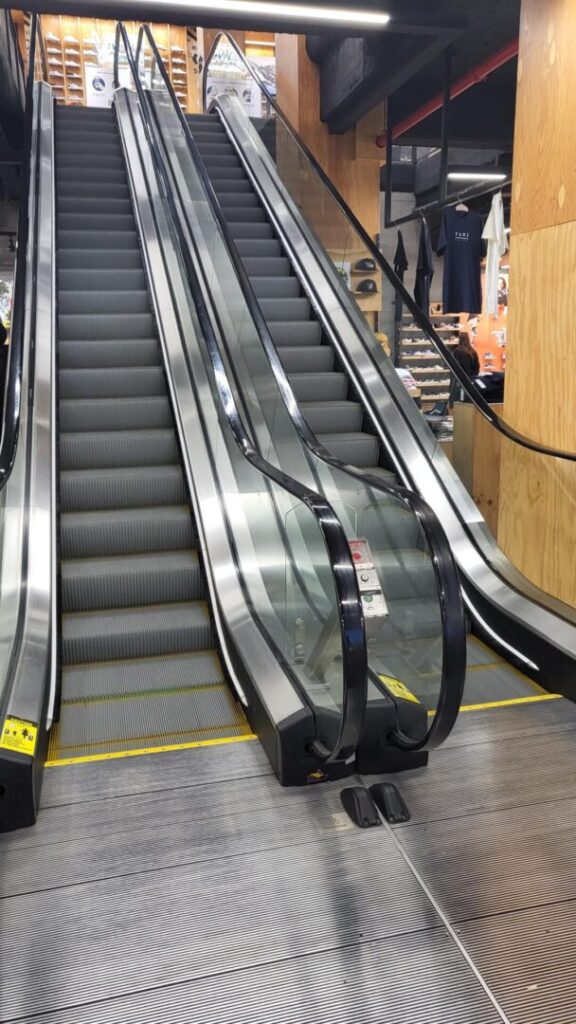 A couple of escalators going down some stairs