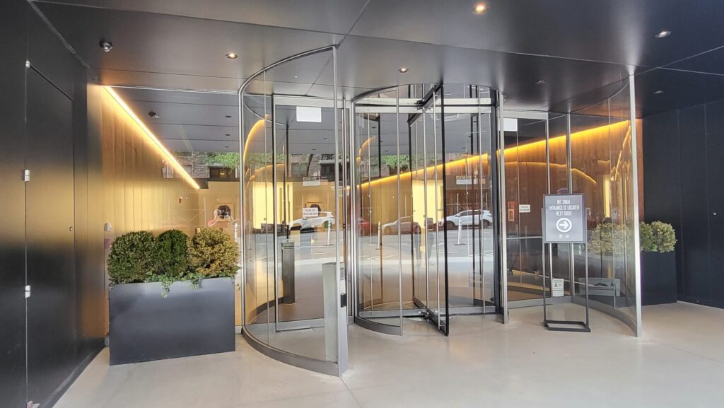 A glass door with a metal frame and a glass wall.