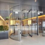 A glass door with a metal frame and a glass wall.