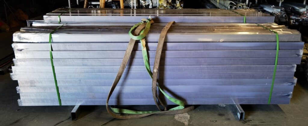 A pair of green and brown leashes hanging on the side of a building.