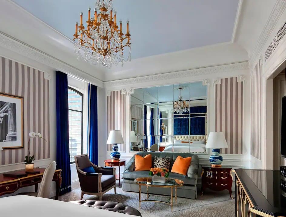 A living room with blue walls and orange accents.