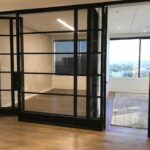 A room with glass doors and wooden floors