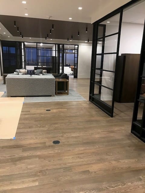 A room with wooden floors and glass doors.