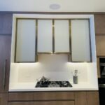 Modern kitchen with built-in stove and sleek cabinetry.