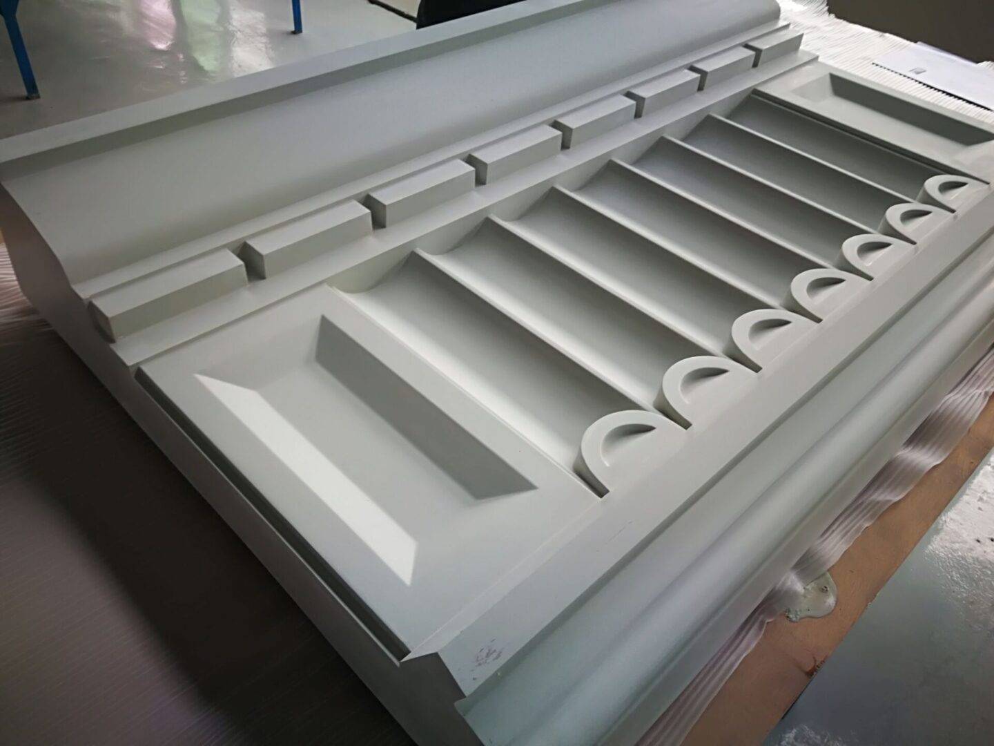 A white table with many drawers and some cups