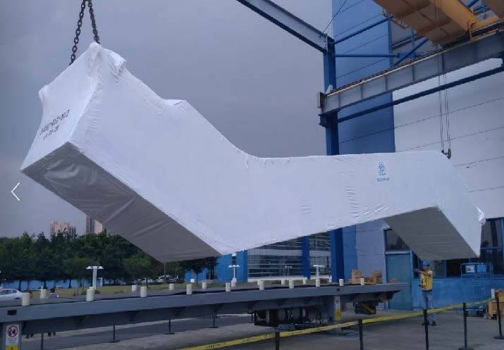 A large white object hanging from the side of a building.