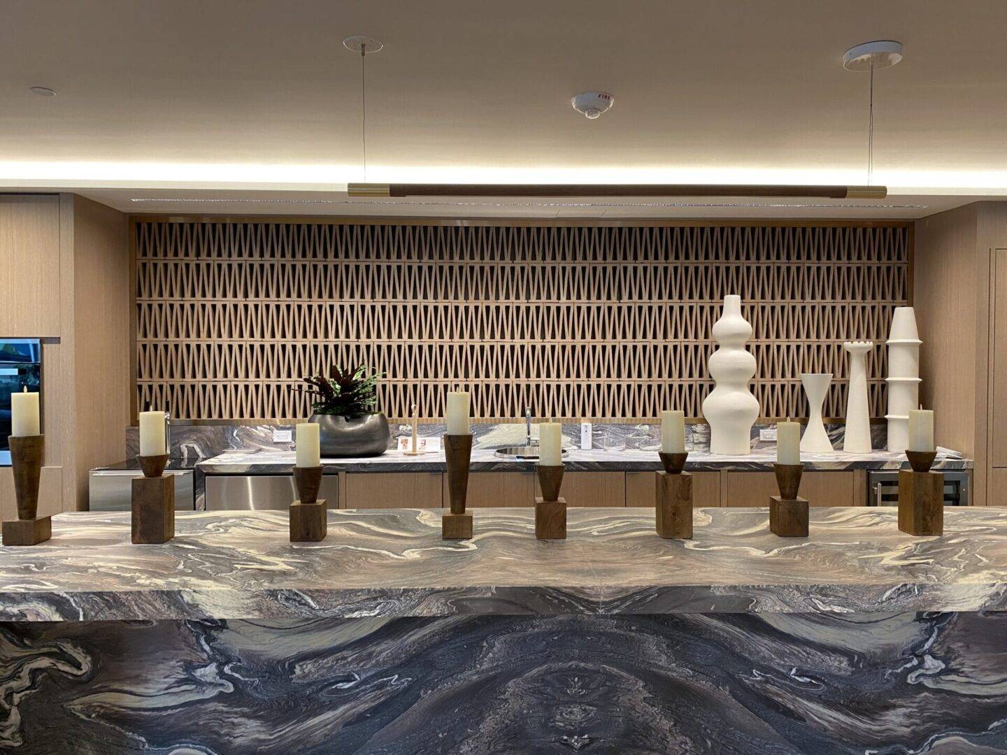 A room with many vases on the counter