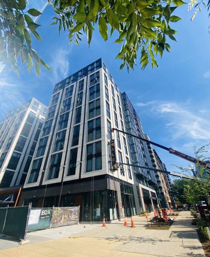 A building that is under construction with trees in the background.