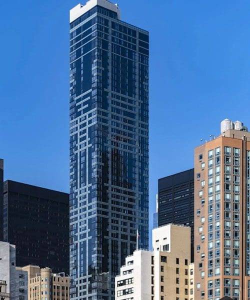 A tall building with many windows in the background