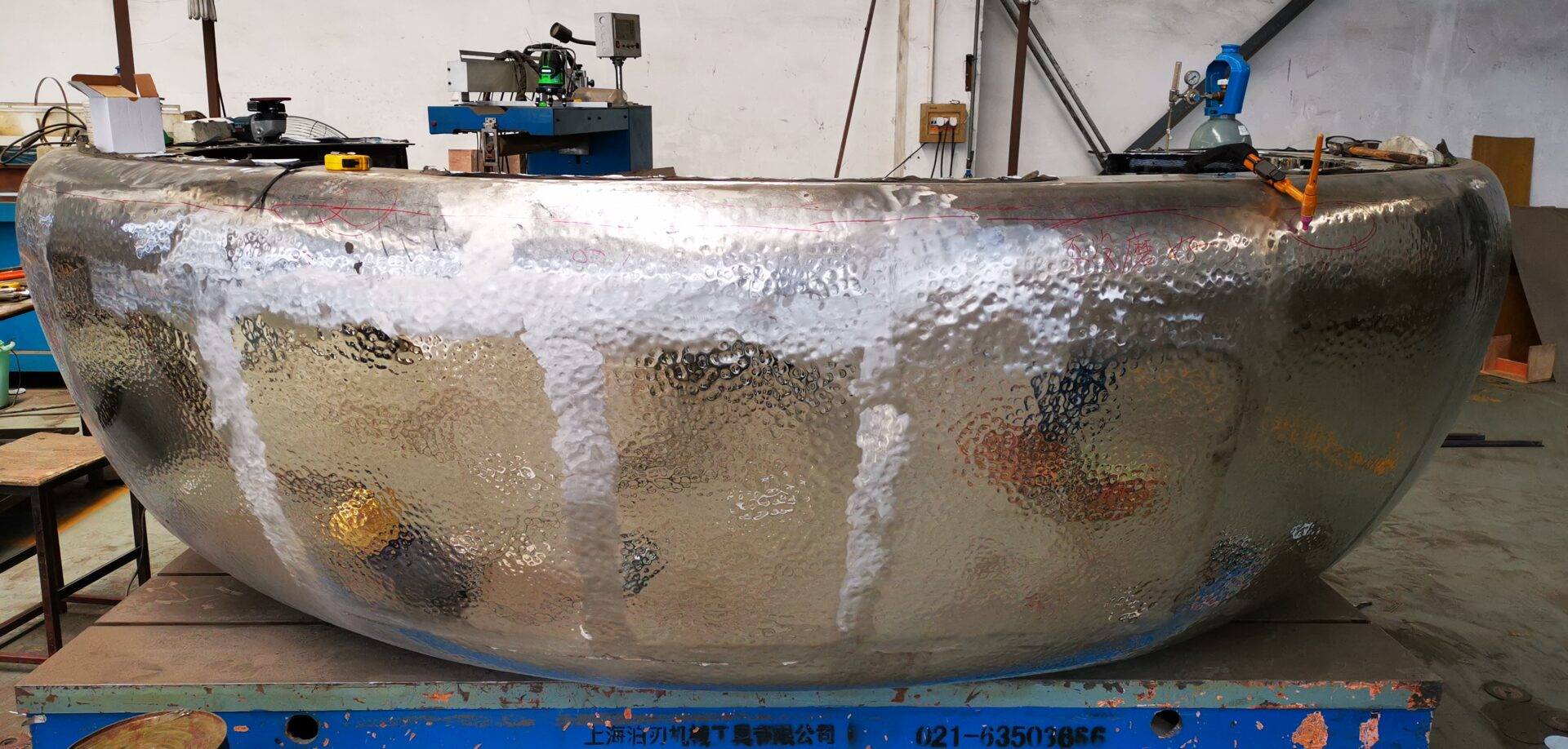 A large metal bowl sitting on top of a table.