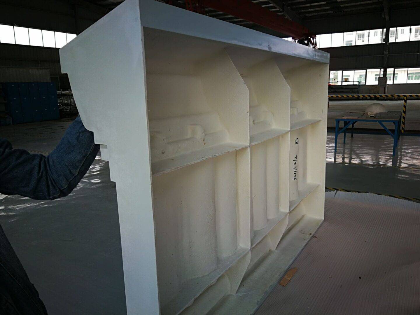 A white shelf in an empty warehouse.