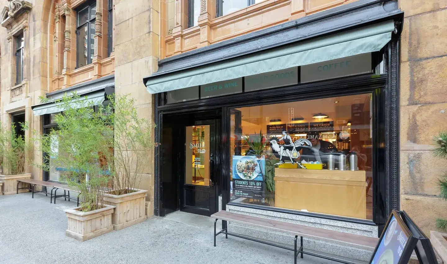 A store front with a bench outside it