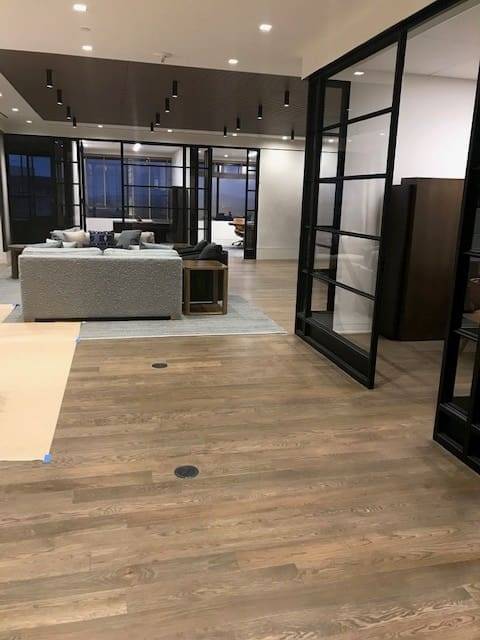 A room with wooden floors and glass doors.